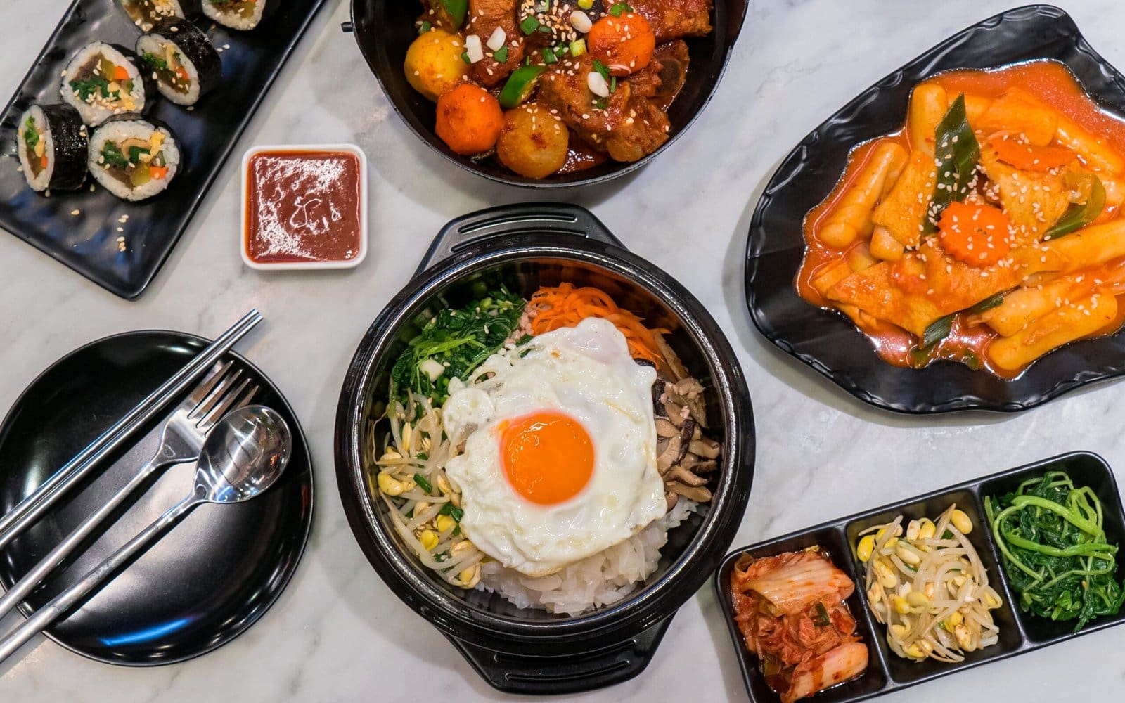 Different Korean foods arranged on a table.